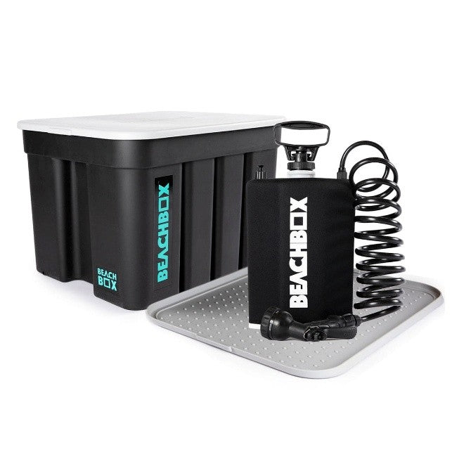 BeachBox storage box with lid beside a portable shower tank and changing mat