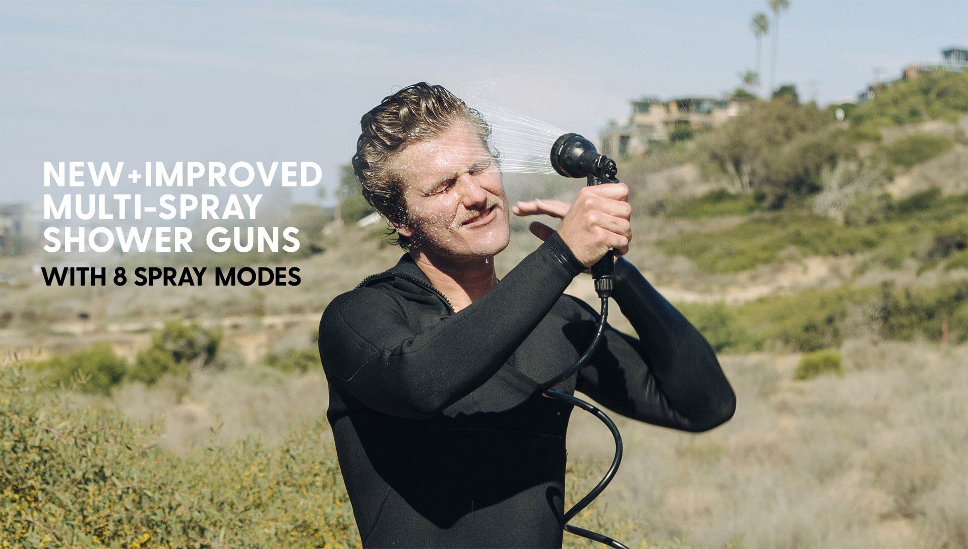 Surfer cleaning himself with new beachbox portable shower gun