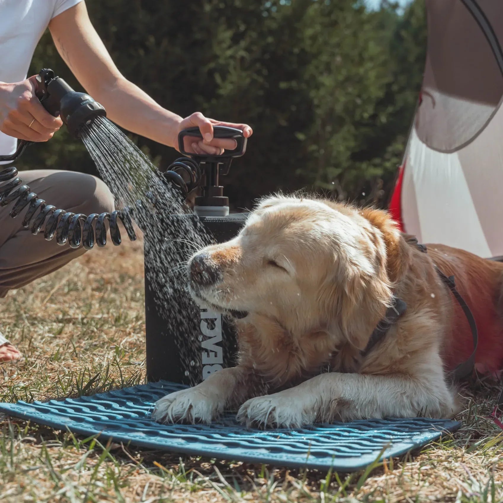 BeachBox portable shower tanks used to rinse dogs after a camping trip